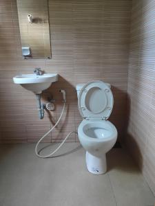 a bathroom with a toilet and a sink at Hans Jensen Residences in Banlot