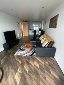 a living room with a couch and a table at Modern 2-Bed Apartment in Glasgow SECC/HYDRO in Glasgow