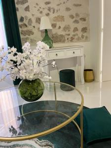 a glass table with a vase with flowers on it at Le Cosy Safranier Vieil Antibes in Antibes