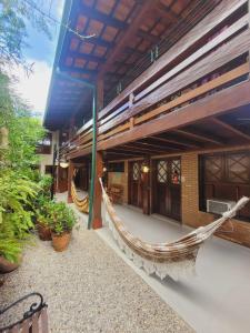 a hammock on the outside of a building at Pousada Don Diego in Ubatuba