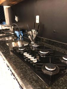 a black stove top oven in a kitchen at Talats_HomeCharm in São Luís