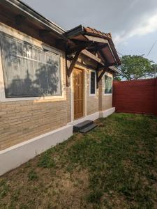 una casa con una puerta de madera y una valla en Casa independiente amoblada en Capiata, en Capiatá