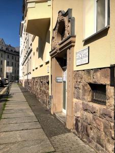 an empty street next to a stone building at Adam's Pension in Chemnitz