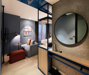 a hotel room with a mirror and a bedroom at RYSE, Autograph Collection, Seoul in Seoul