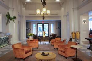 a lobby of a hotel with chairs and tables at International House Hotel in New Orleans