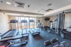 a gym with several tread machines in a room at SunwayLagoonFamilySuite-4-7pax-Netflix-Balcony-Super Fast Internet in Kampong Penaga