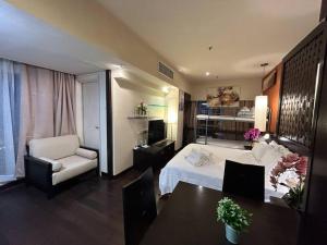 Kampong Penaga的住宿－SunwayLagoonFamilySuite-4-7pax-Netflix-Balcony-Super Fast Internet，卧室配有1张床、1张桌子和1把椅子