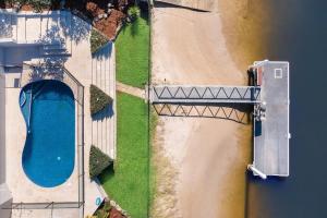 an overhead view of a bridge over a body of water at Sorrento Waterfront Retreat,Pool in Gold Coast