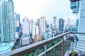 a view of a city from the balcony of a building at Sky Staycation KL Greenbelt, Isabel's Makati Rooms in Manila