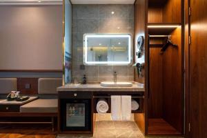 a bathroom with a sink and a mirror at Nostalgia S Hotel - Beijing Xidan Financial Street in Beijing