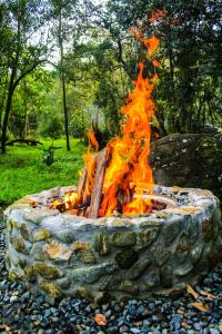 a fire pit in the middle of a field at Vital Ecohotel Cabañas in Guarne