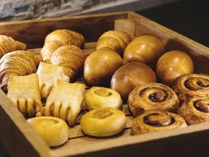 a wooden box filled with lots of different types of pastries at R&B HOTEL UENO HIROKOJI - Vacation STAY 13873v in Tokyo