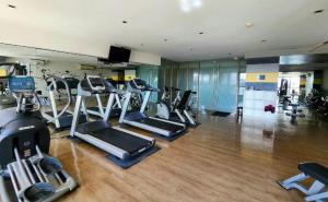 a gym with a bunch of cardio machines in it at Sky Staycation KL Greenbelt, Isabel's Makati Rooms in Manila