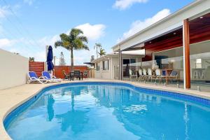 a swimming pool in front of a house at Mooloolaba Oasis 4bd Home, Pool in Mooloolaba