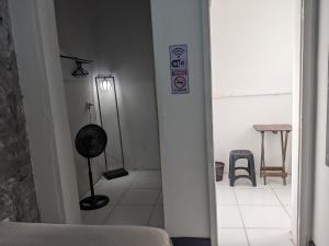a white room with a room with a table and a sign at Youkoso Hostel in Florianópolis