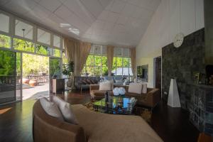 a living room with a couch and a table at Sweeping Mountain View Retreat at La Cantane Villa in Kundasang