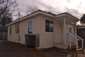 a small white house with a porch and a driveway at Bright and Cozy Lighthouse Cottage in Greenville SC in Greenville