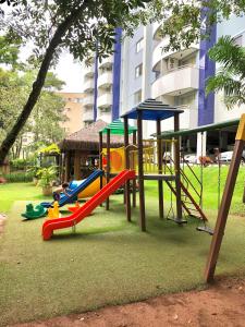 a playground with a slide in a park at Apart Hotel no Rio Quente- Cond. Águas da Serra in Rio Quente