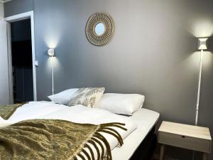 a bedroom with a bed and a mirror on the wall at Middle of the town Stavanger BnB -Billiard and Sauna at Bertis Apartment 15 in Stavanger