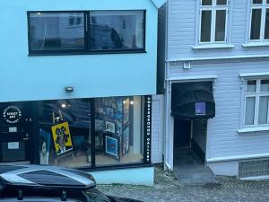 a building with a car parked in front of it at Middle of the town Stavanger BnB -Billiard and Sauna at Bertis Apartment 15 in Stavanger