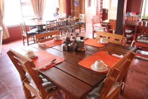 a wooden table in a restaurant with red napkins at Dunedin Star Guesthouse in Swakopmund