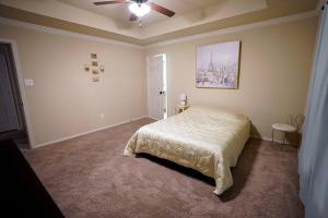 a bedroom with a bed and a ceiling fan at North Little Rock Home Near Bases in North Little Rock