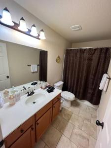 a bathroom with a sink and a toilet and a mirror at North Little Rock Home Near Bases in North Little Rock
