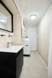 a kitchen with a white refrigerator in a room at 3 rooms, Hongdae, Shinchon unshared Villa in Seoul