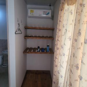 a bathroom with a heater and a shower curtain at Posada Salt Creek in Providencia