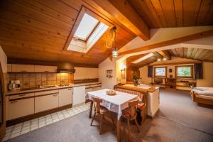 a kitchen and dining room with a table and chairs at Ferienhaus Larinmos in Lermoos