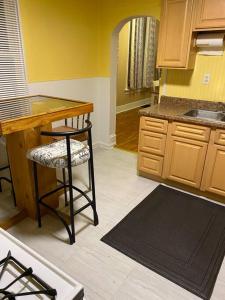 a kitchen with a counter and a stool and a table at Cozy home 5 beds private yard in Cincinnati