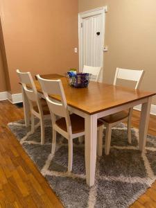 a dining room table with white chairs and a wooden table at Cozy home 5 beds private yard in Cincinnati