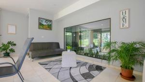 a living room with a couch and a large mirror at River Paradise Villa in Fortuna