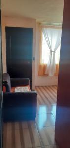 a living room with a couch and a window at Casa N Campestre uno en las faldas de Taita Imbabura in Hacienda Chichavo