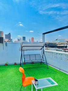 a table and a chair on a roof at Daraya Hostel in Bangkok