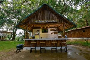 a bar with stools in front of a building at Almost Heaven Lake Resort by Cocotel in Cavinti