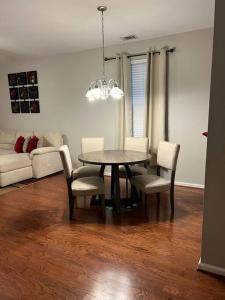 a dining room table and chairs in a living room at Cheerful 3 bedroom, close to downtown and arena!!! in Savannah