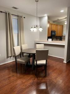 a dining room with a table and chairs and a kitchen at Cheerful 3 bedroom, close to downtown and arena!!! in Savannah