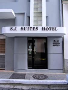 a white building with a s st suites hotel at SJ SUITES HOTEL in San Juan