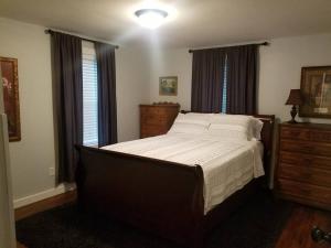 a bedroom with a large bed and a window at The Sanctuary 14 acres w/pond/fishing/trails/etc. in Nashville