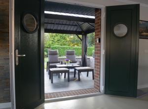 a door leading into a patio with a table and chairs at Ferienwohnung Sofia in Papenburg