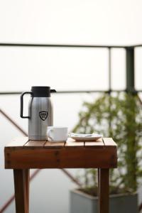 a coffee pot sitting on a wooden table at Vayalada Valley View Resort in Bālūssheri