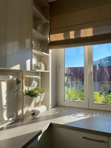 a kitchen with a window with a view of the city at Light Room by Zoom Apartments in Bratislava