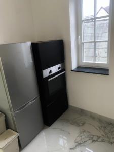 a kitchen with a black refrigerator and a window at PrimeBnb LuxusApartment in Wetzlar