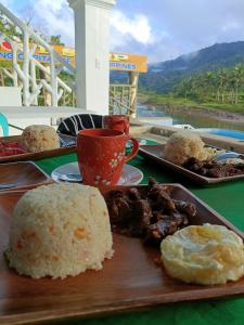 a table with plates of food and a cup of coffee at San Miguel River Park (SMRP) Glamping 