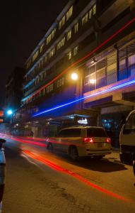 a car driving down a city street at night at HOTEL CENTRAL PARK & CONFERENCE CENTRE in Nairobi