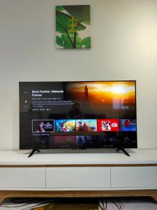 a flat screen tv sitting on top of a white cabinet at Sofia Homes Kuala Terengganu in Kuala Terengganu