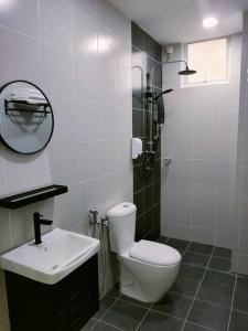 a bathroom with a toilet and a sink and a shower at Sofia Homes Kuala Terengganu in Kuala Terengganu