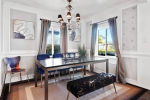 a dining room with a table and blue chairs at Luxury Home - 7mins LAX/Beach, 405/SoFi nearby in Hawthorne