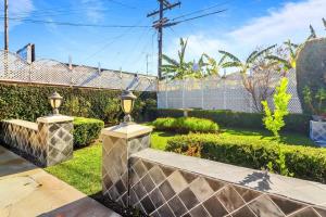 a garden with two stone benches and bushes at Luxury Home - 7mins LAX/Beach, 405/SoFi nearby in Hawthorne